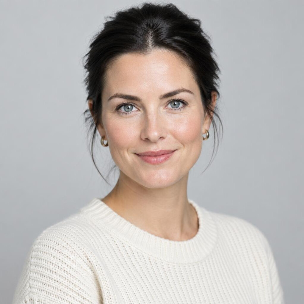 Portrait of a young woman with dark hair and a soft smile