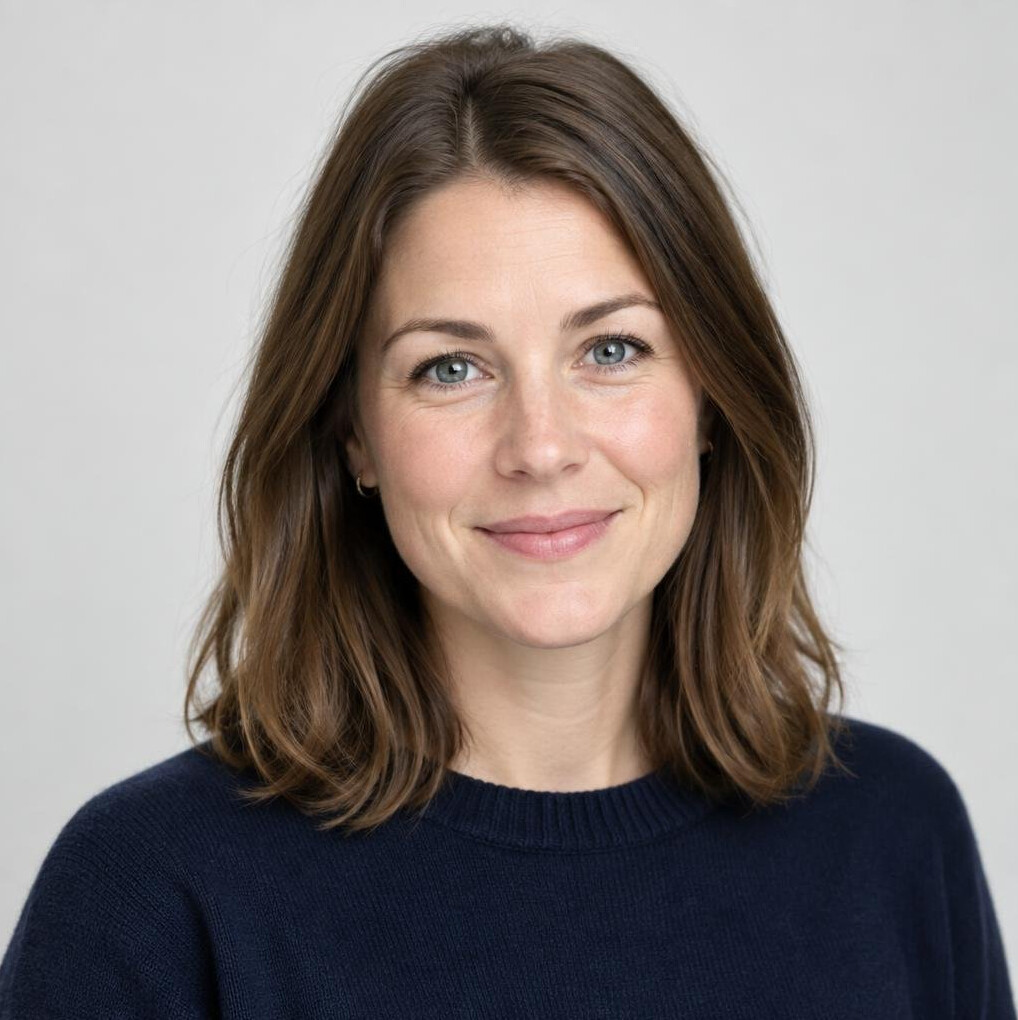 Portrait of a young Scandinavian woman with brown hair smiling in a studio