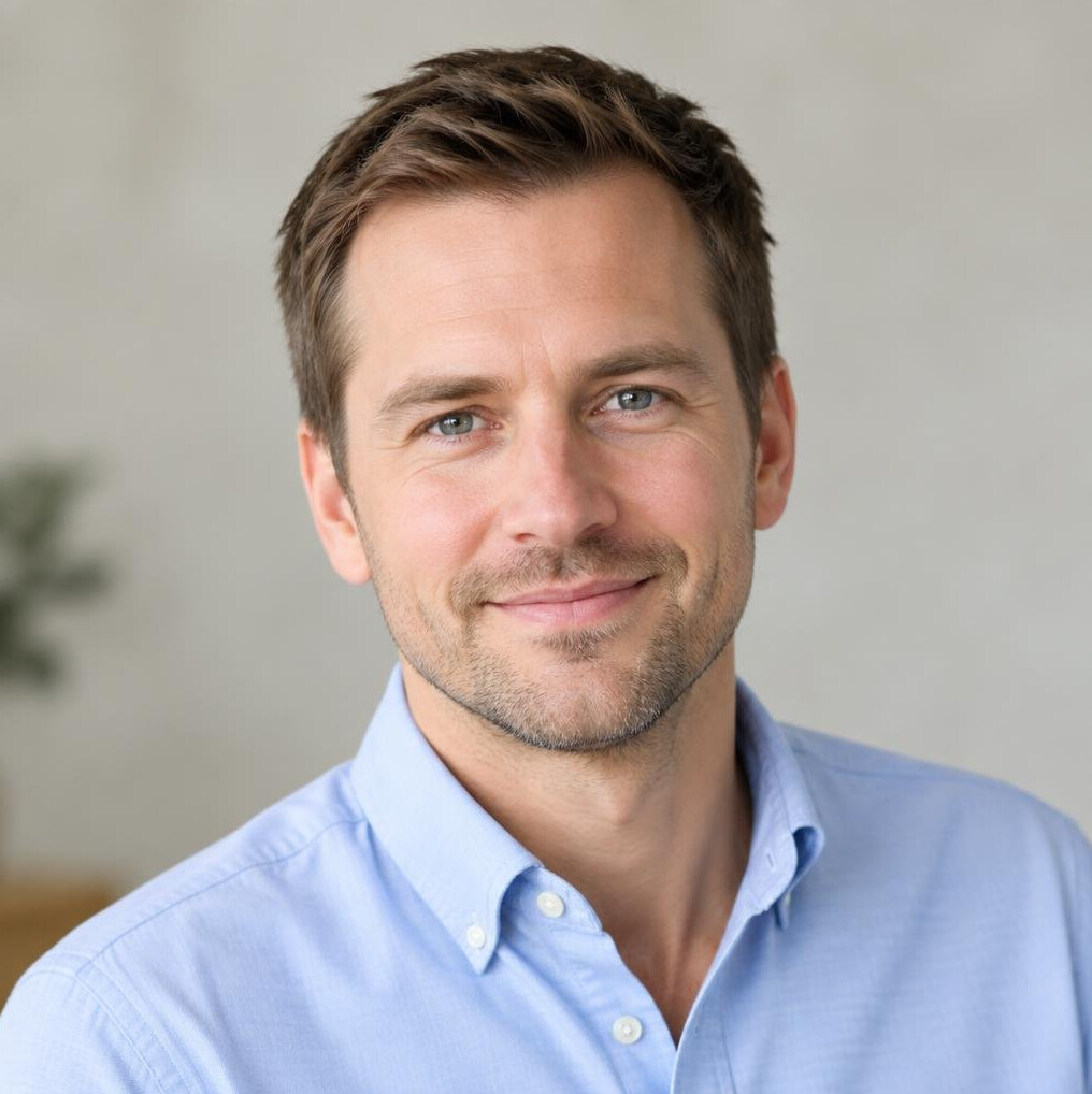 Portrait of a man in his thirties with short brown hair and a light shirt